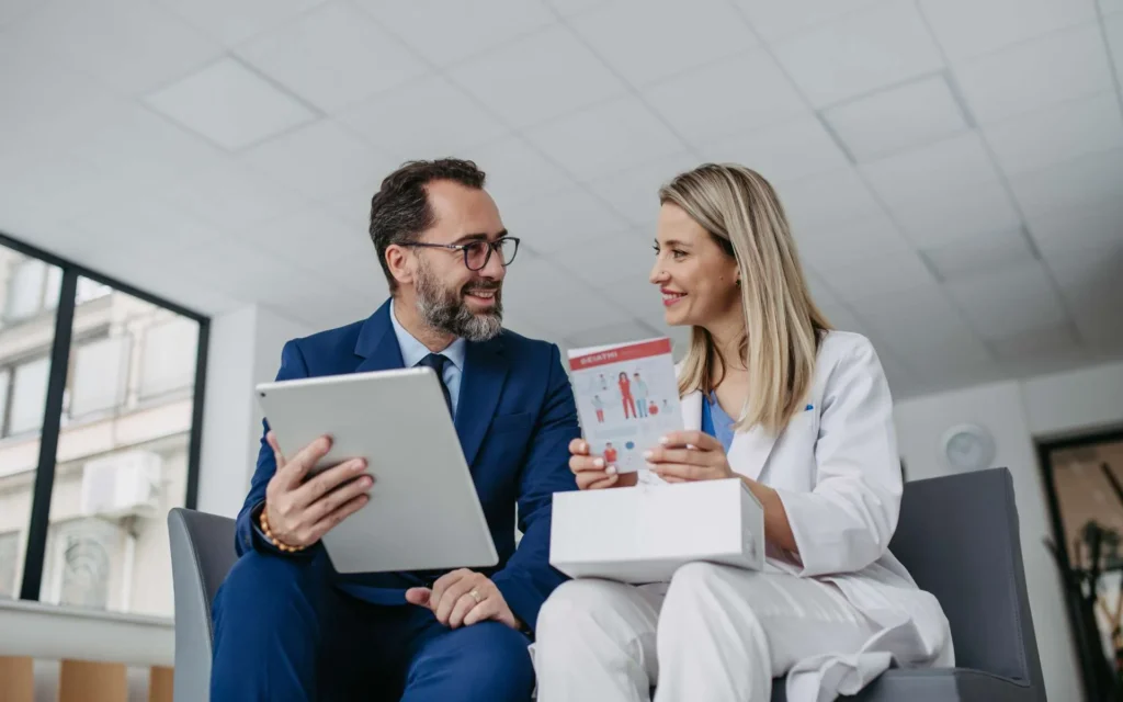 A man and a woman looking at a tablet