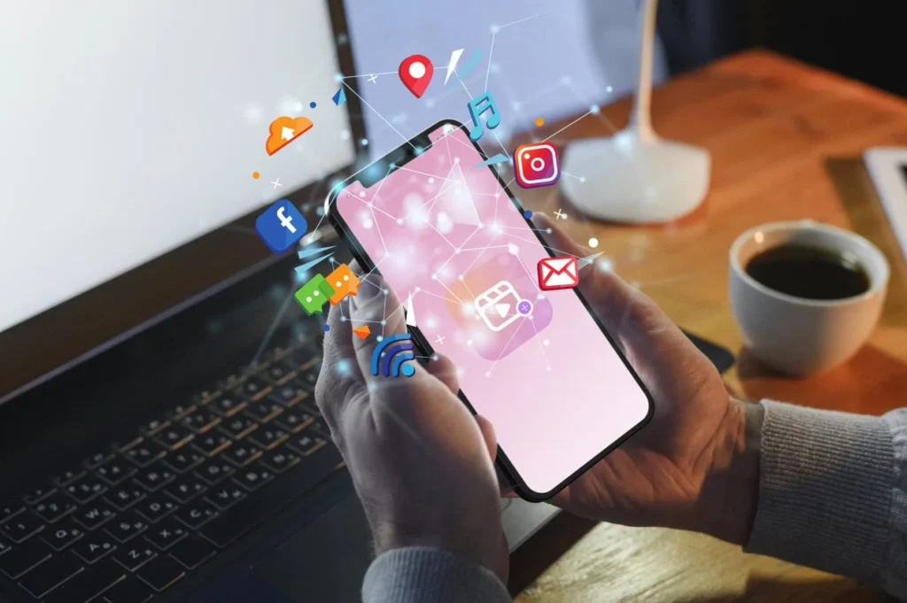 A phone which is surrounded by social media icons